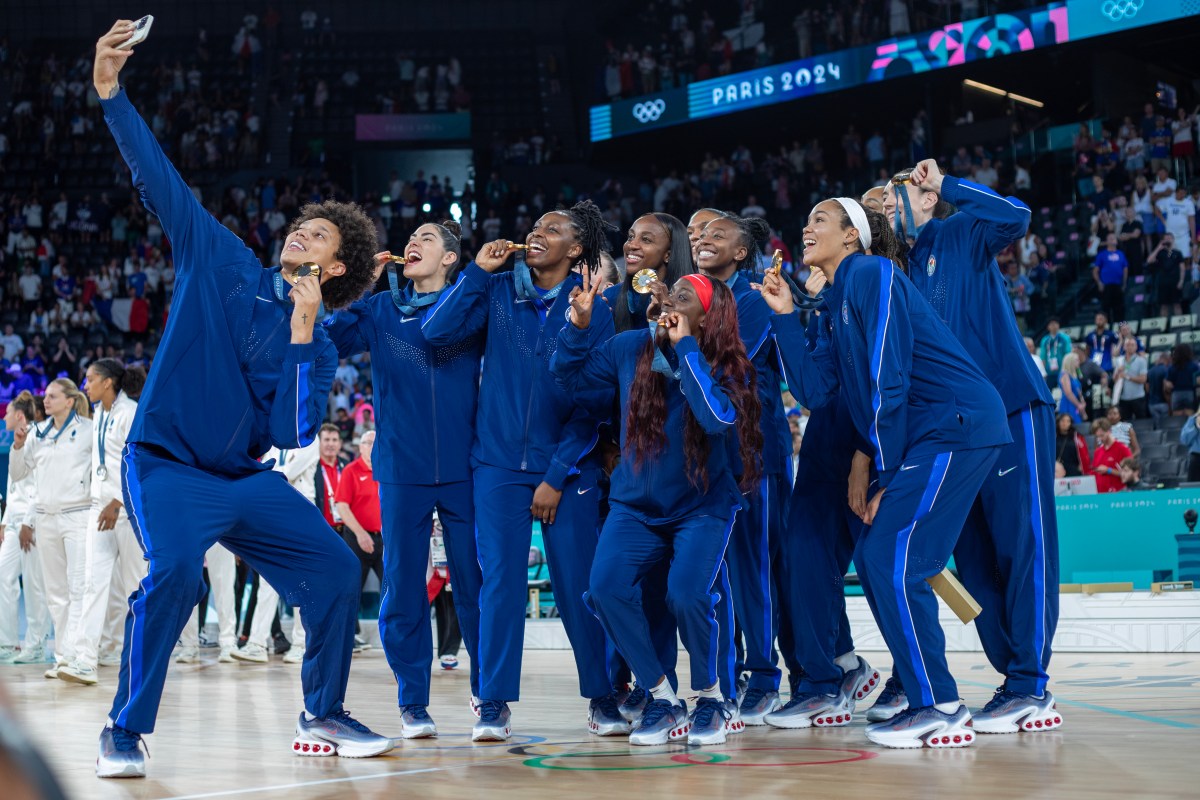 PARIS, FRANCE: AUGUST 11: Brittney Griner takes a selfie of The United States team of Jewell Loyd, Kelsey Plum, Sabrina Ionescu, Kahleah Copper, Chelsea Gray, A'Ja Wilson, Breanna Stewart, Napheesa Collier, Diana Taurasi, Jackie Young, and Alyssa Thomas as they celebrate with their gold medals after the Women's Basketball Medal Games at the Bercy Arena during the Paris 2024 Summer Olympic Games on August 11th, 2024 in Paris, France. (Photo by Tim Clayton/Corbis via Getty Images)