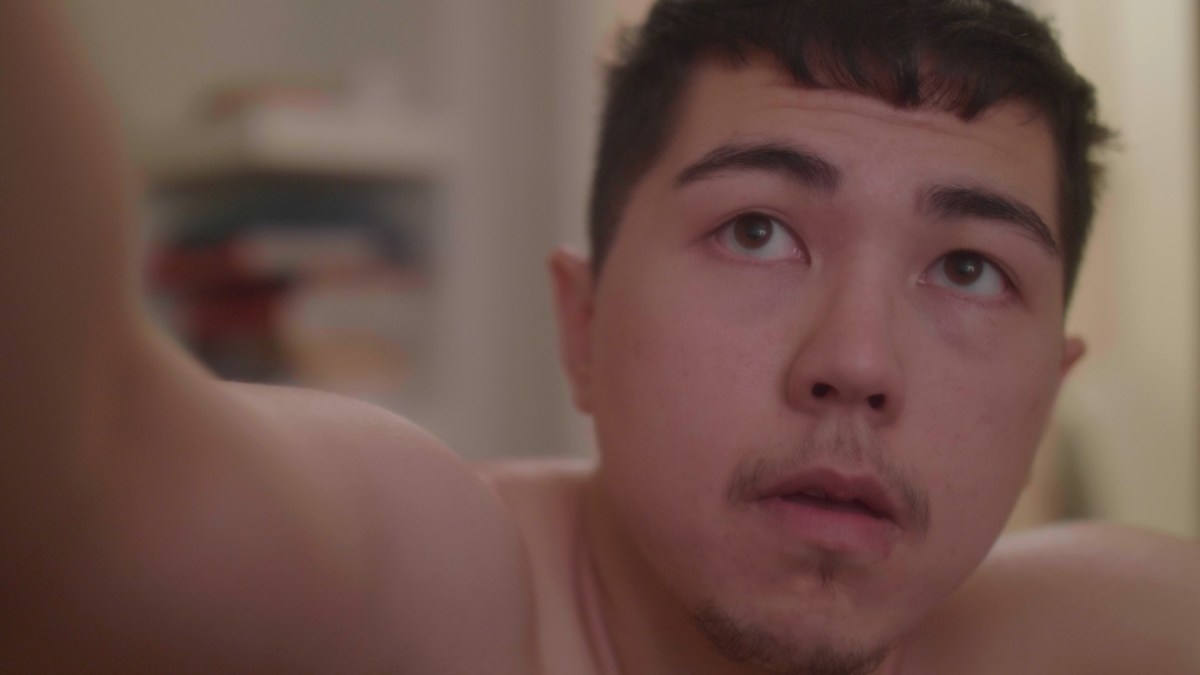 A close up on a trans guy's face.