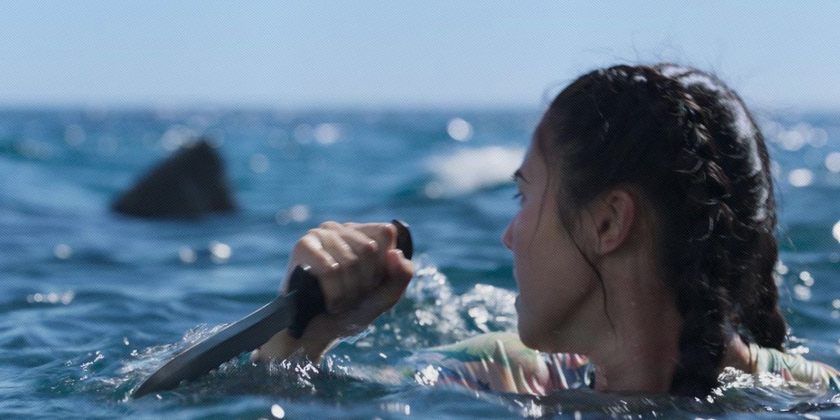 a girl with a knife in the ocean