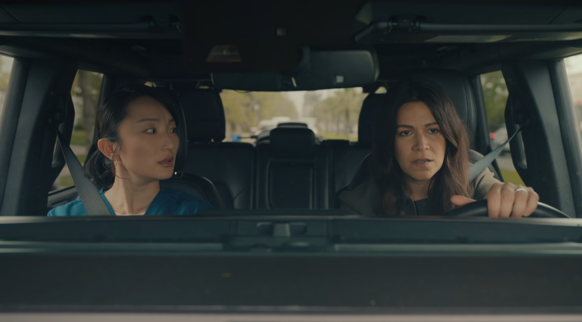 Poppy Liu and Abbi Jacobson look serious in a car.