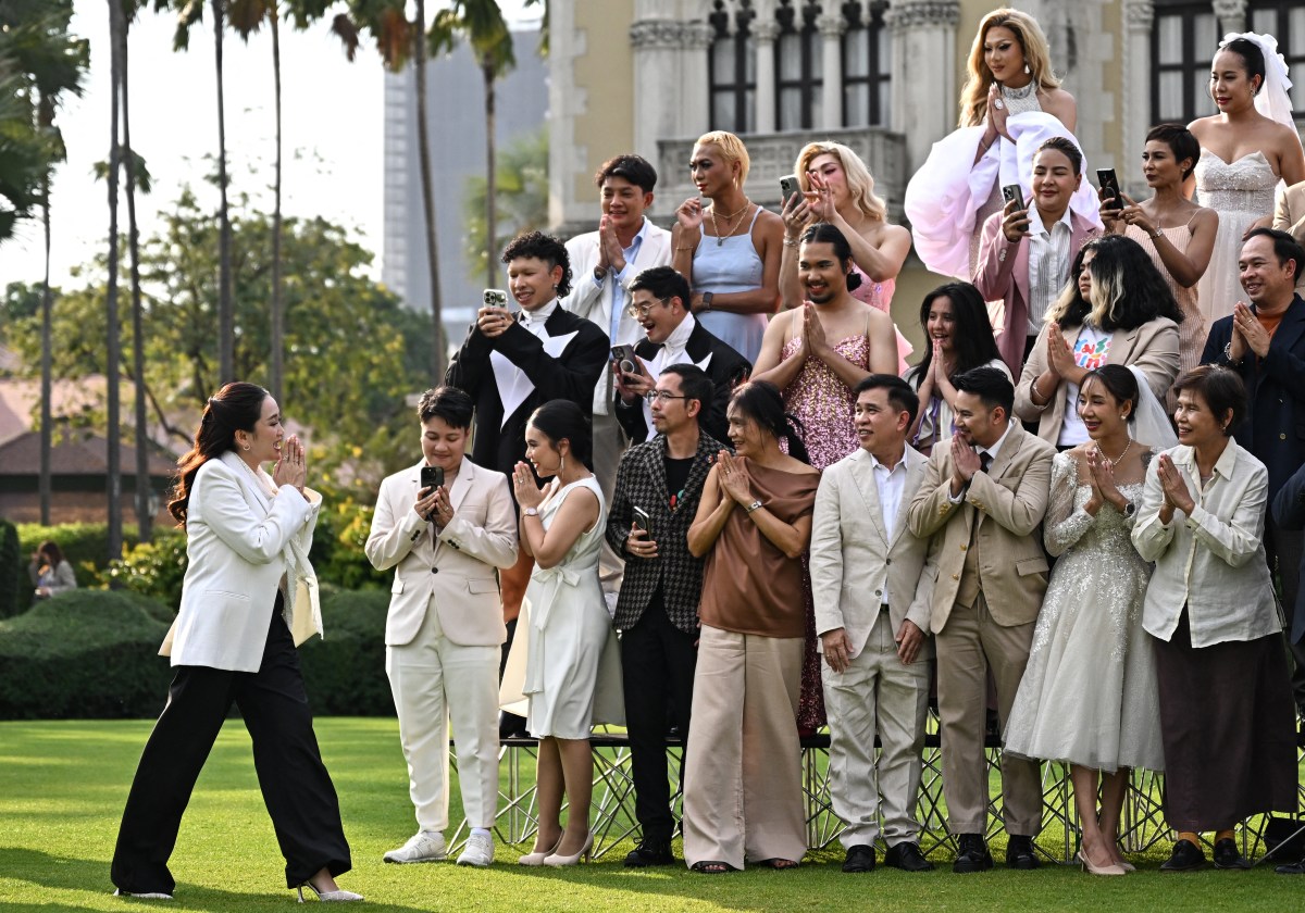 Thailand's Prime Minister Paetongtarn Shinawatra, known by her nickname as "Ung Ing" (L) greets same-sex couples and members of LGBTQ community as she arrives to pose for photos to promote "Marriage Equality Day" at the Government House in Bangkok on January 15, 2025. (Photo by Manan VATSYAYANA / AFP) (Photo by MANAN VATSYAYANA/AFP via Getty Images)