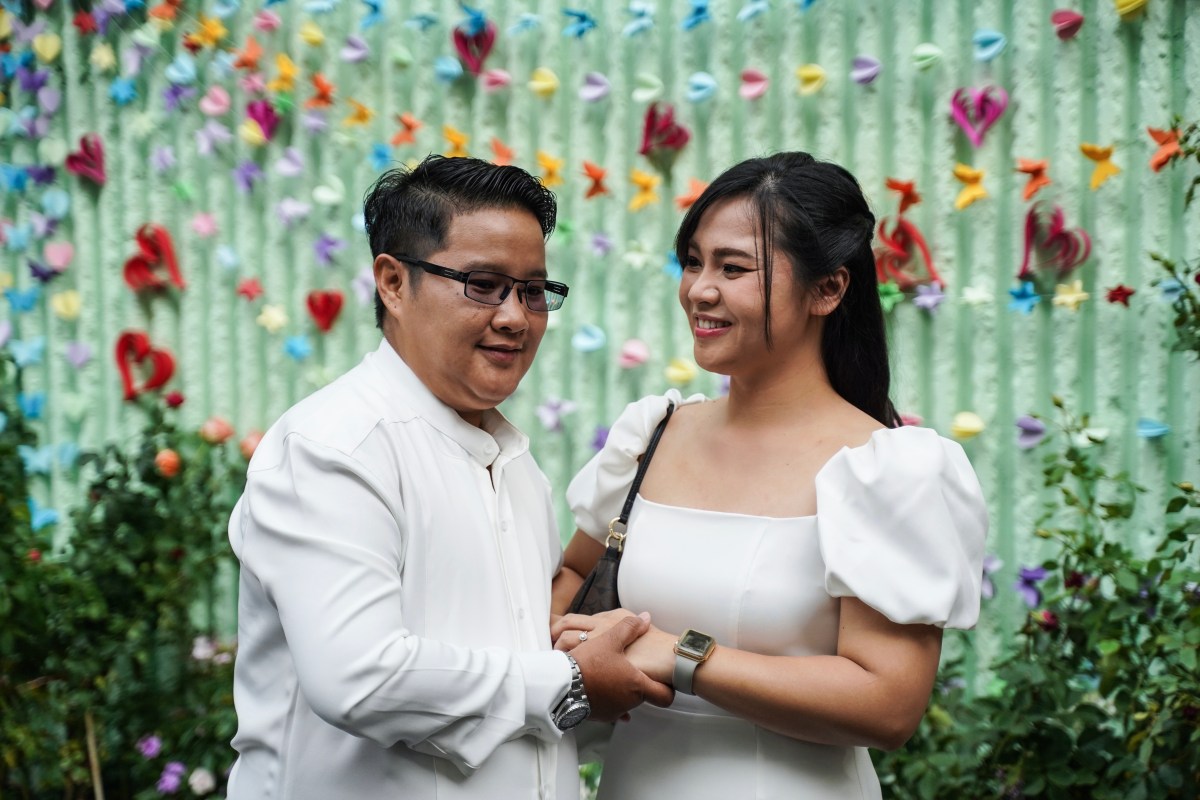 A couple poses for pictures at a marriage during an event to mark the country's same-sex marriage law coming into effect in BangRak District, Bangkok, Thailand, on January 23, 2025. (Photo by Anusak Laowilas/NurPhoto via Getty Images)