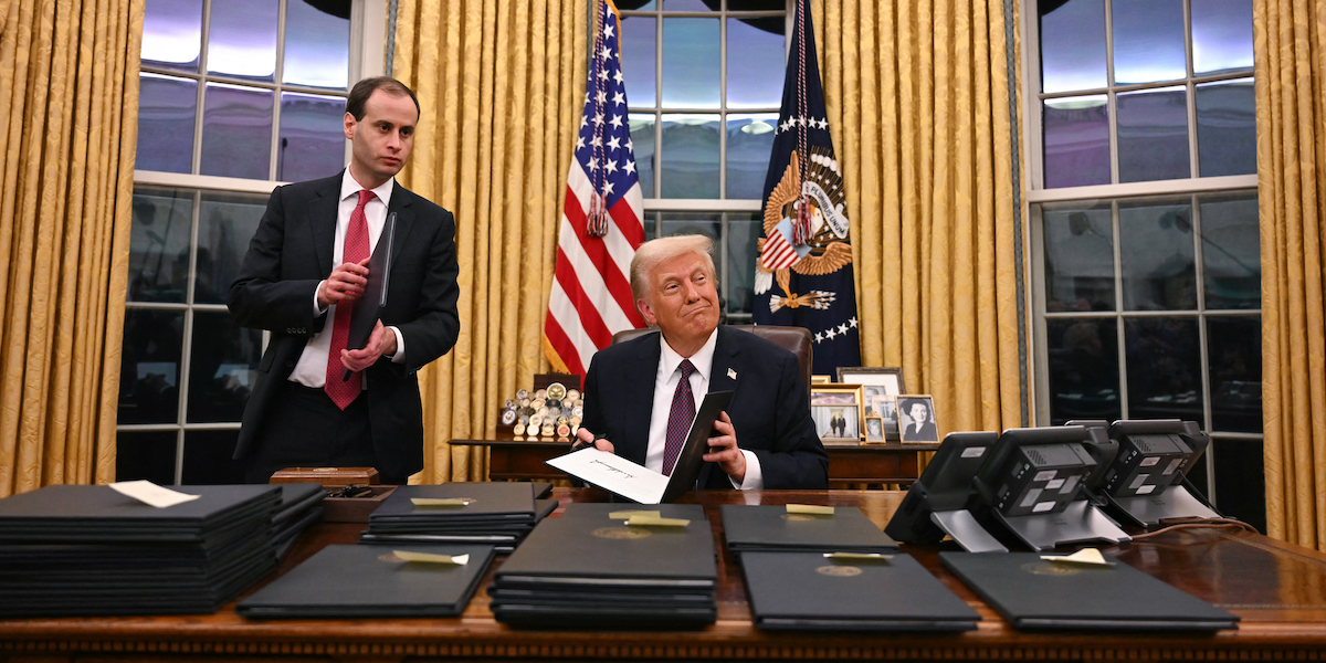 US President Donald Trump signs executive orders in the Oval Office of the WHite House in Washington, DC, on January 20, 2025. (Photo by Jim WATSON / AFP)