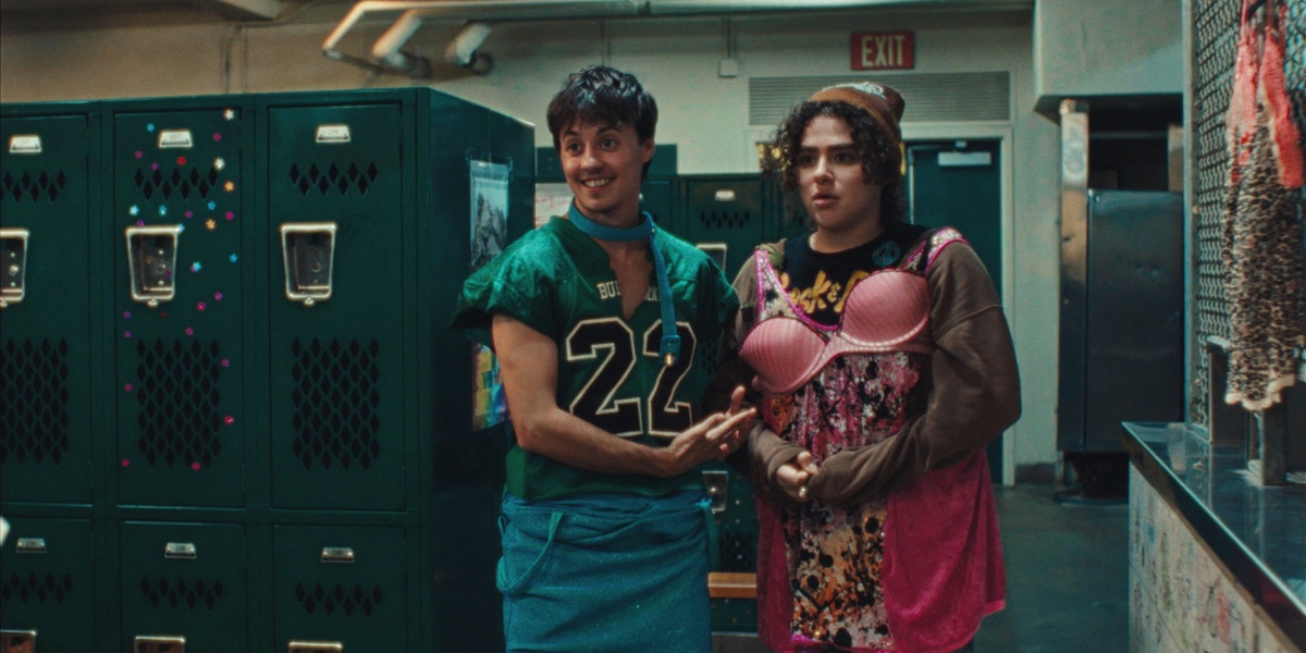 Nico Carney interview: Nico in a football jersey and a skirt stands in a locker room next to Misha Osherovich haphazardly wearing a pink bra.