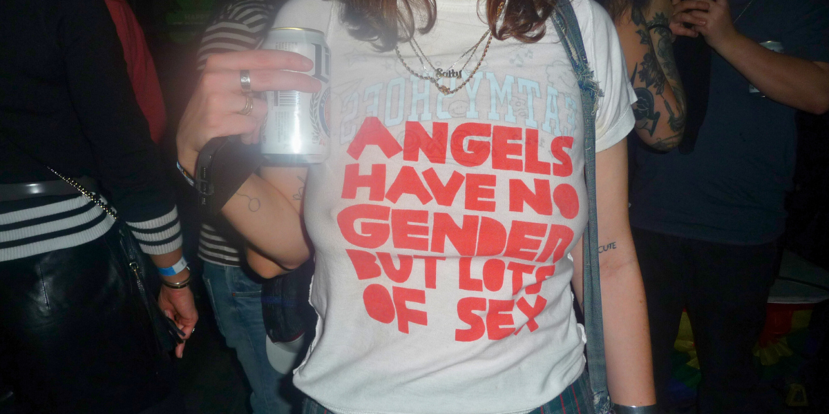 someone inside Ginger's with a shirt that says ANGELS HAVE NO GENDER BUT LOTS OF SEX