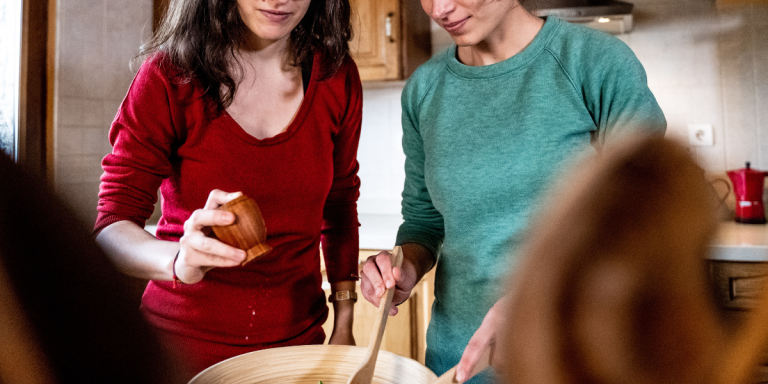 two women salting a bowl