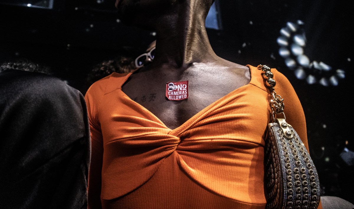 Heavenly Bodies someone wears a sticker saying NO CAMERAS ALLOWED