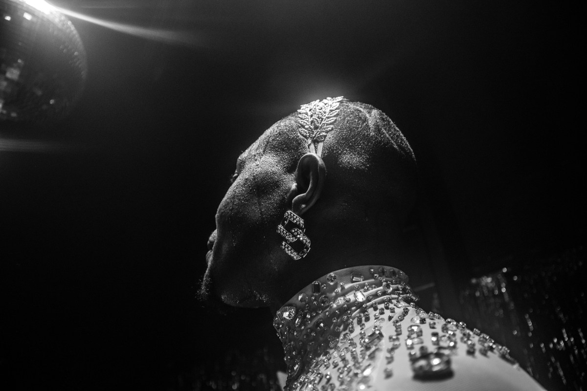 Heavenly Bodies a ballroom performer wearing a jeweled headpiece and bedazzled mock neck