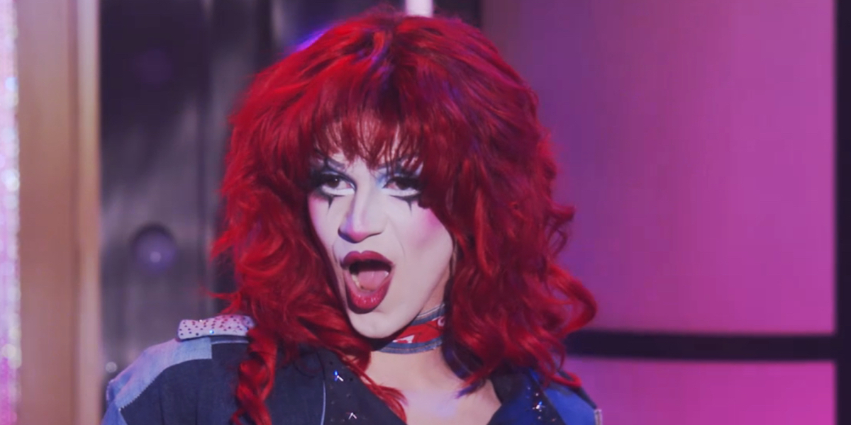 RuPaul's Drag Race 1715 recap: a close up of Suzie Toot in white makeup and a shaggy red wig lip syncing