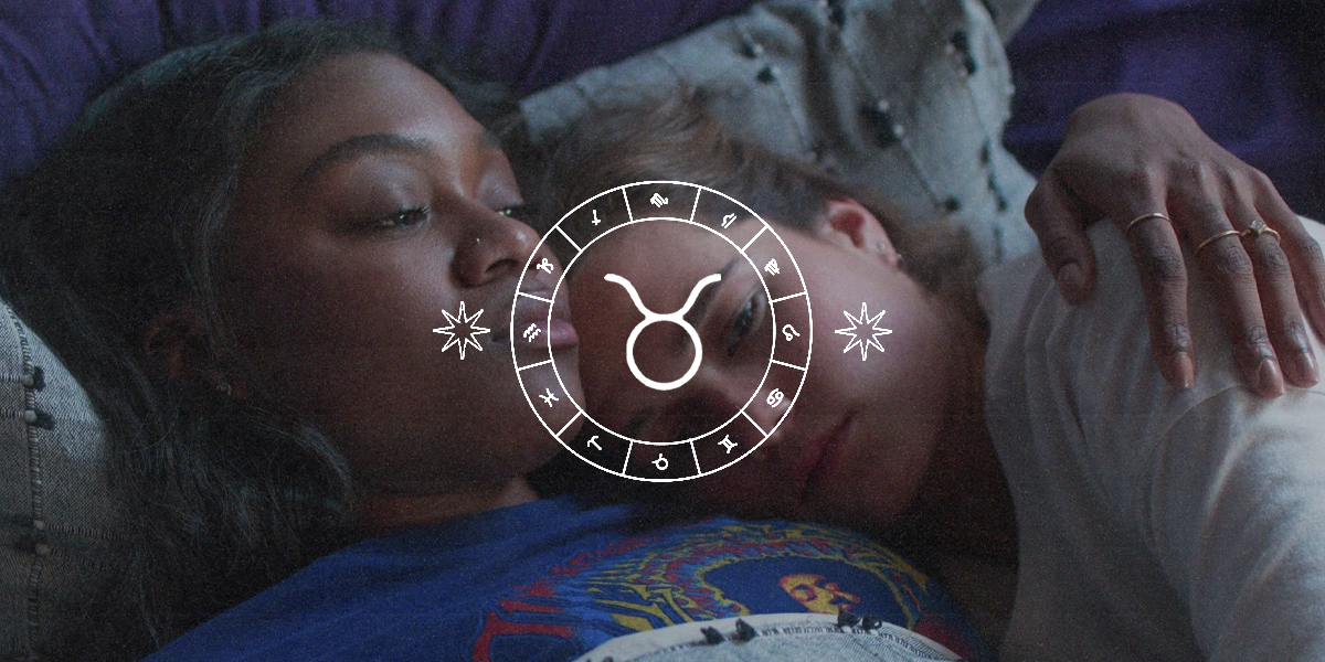 Queer Horoscopes for Taurus Season 2025: a still from First Kill of the two leads lying in bed with the Taurus symbol over them.