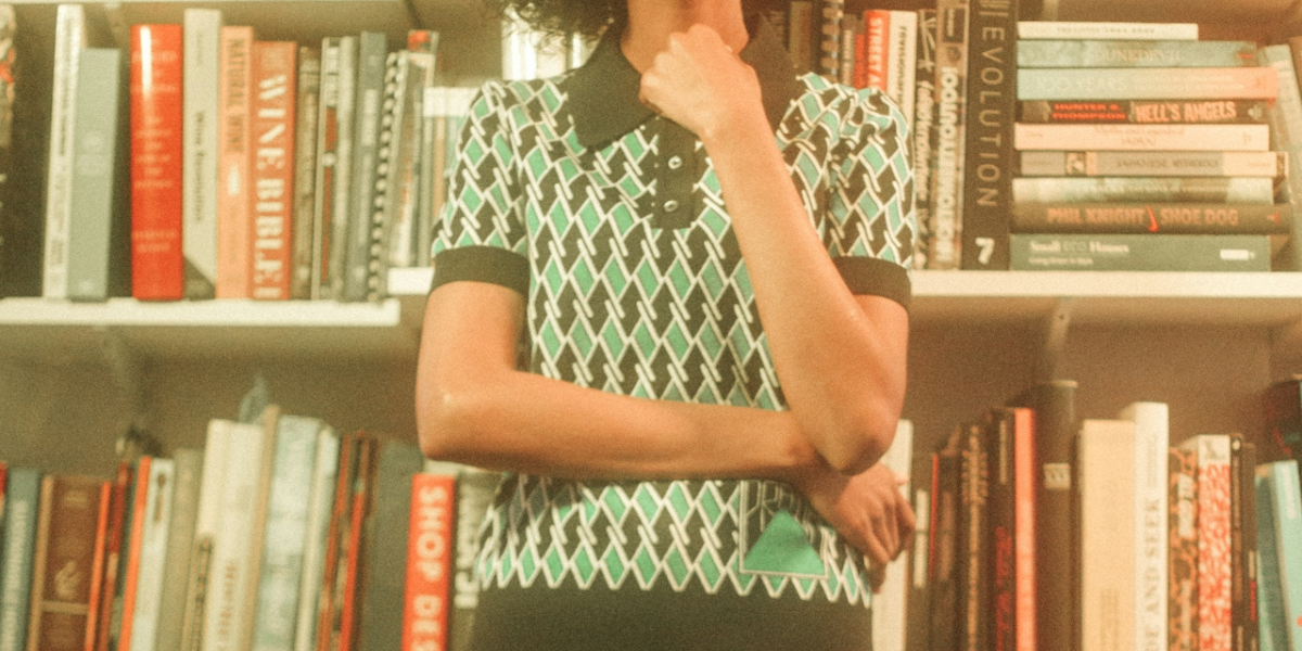 a person standing in front of shelves of books