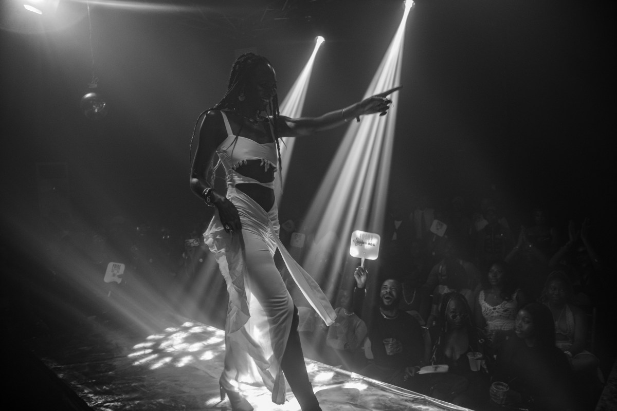 Heavenly Bodies a ballroom performer points out at attendees