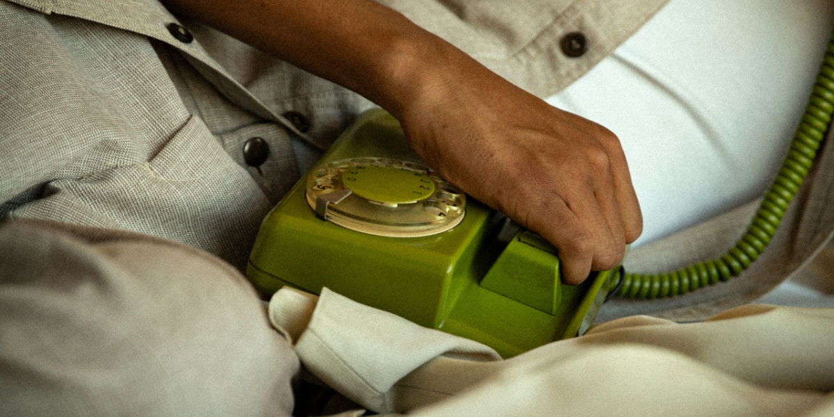 a corded phone and a hand