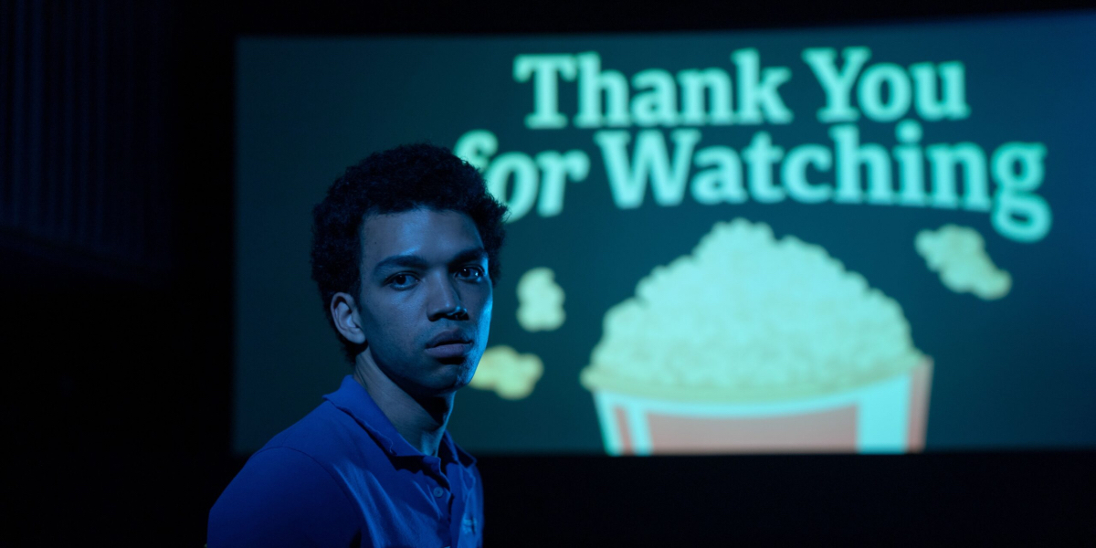 Justice Smith in I Saw the TV Glow with Thank You for Watching behind him.