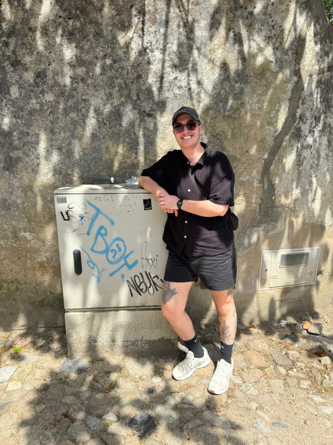 Motti next to a box that says TBOY