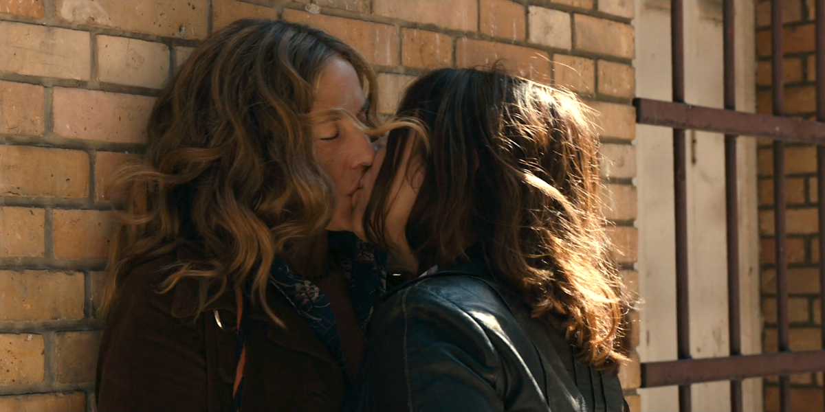 Two women have a hot lesbian summer make out against a brick wall in Summertime