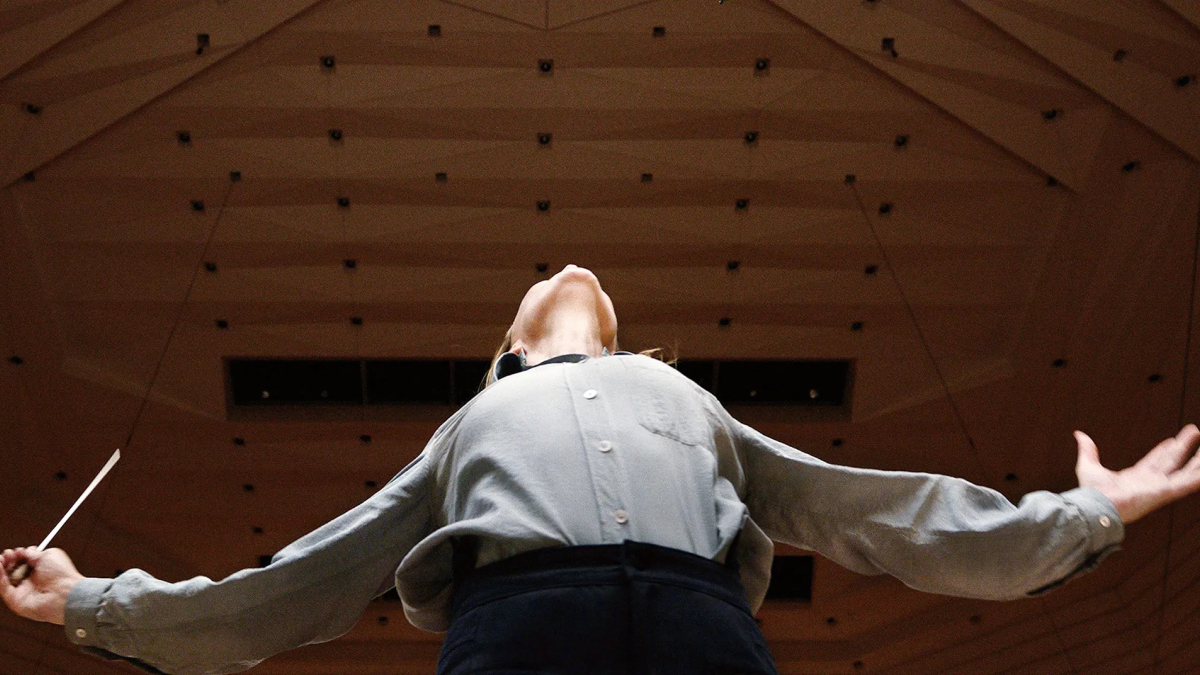 A shot from below of Cate Blanchett conducting in Tár