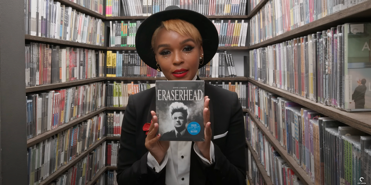 Janelle Monáe holds up a copy of Eraserhead in The Criterion Collection closet