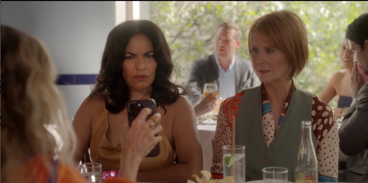 miranda and seema scowling at a phone