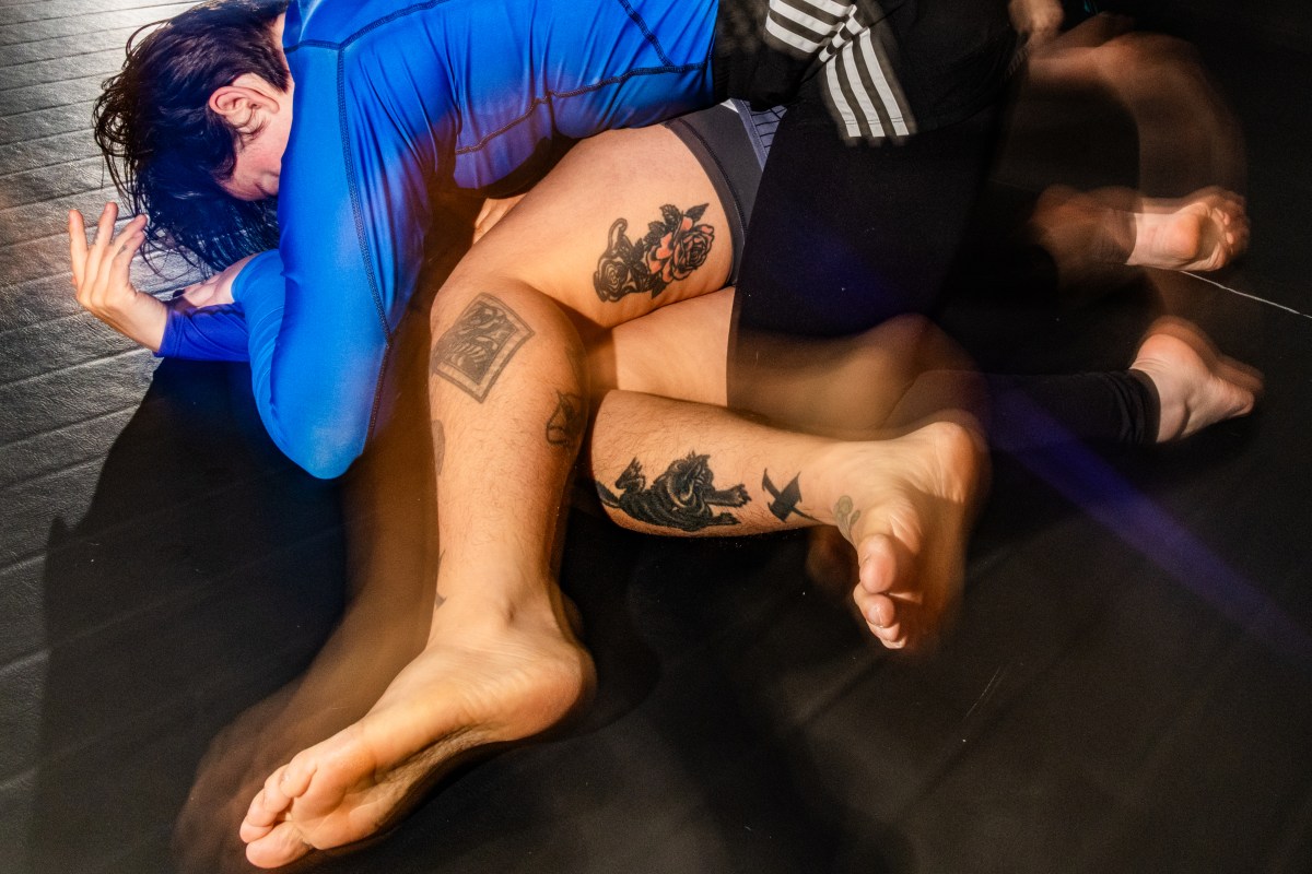 Irina Groushevaia demonstrates a pin with Mylo in jiu-jitsu training.