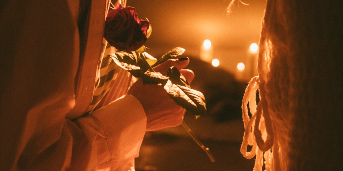 a woman handing a rose to another woman