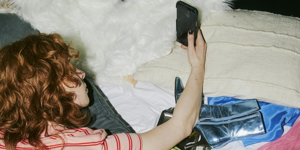 a person in bed with a phone