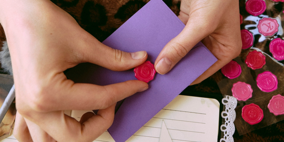 a person putting together a letter for an ex